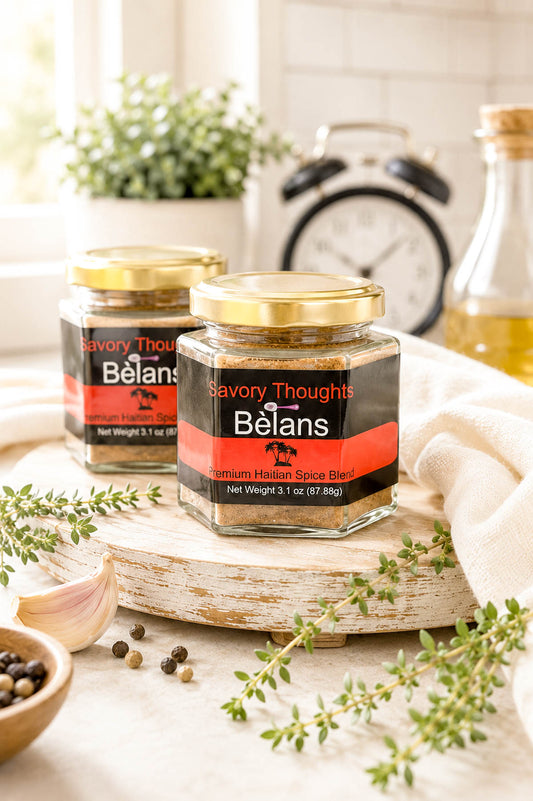Two jars of Belans savory thoughts spice mix on a wooden surface with herbs and garlic.