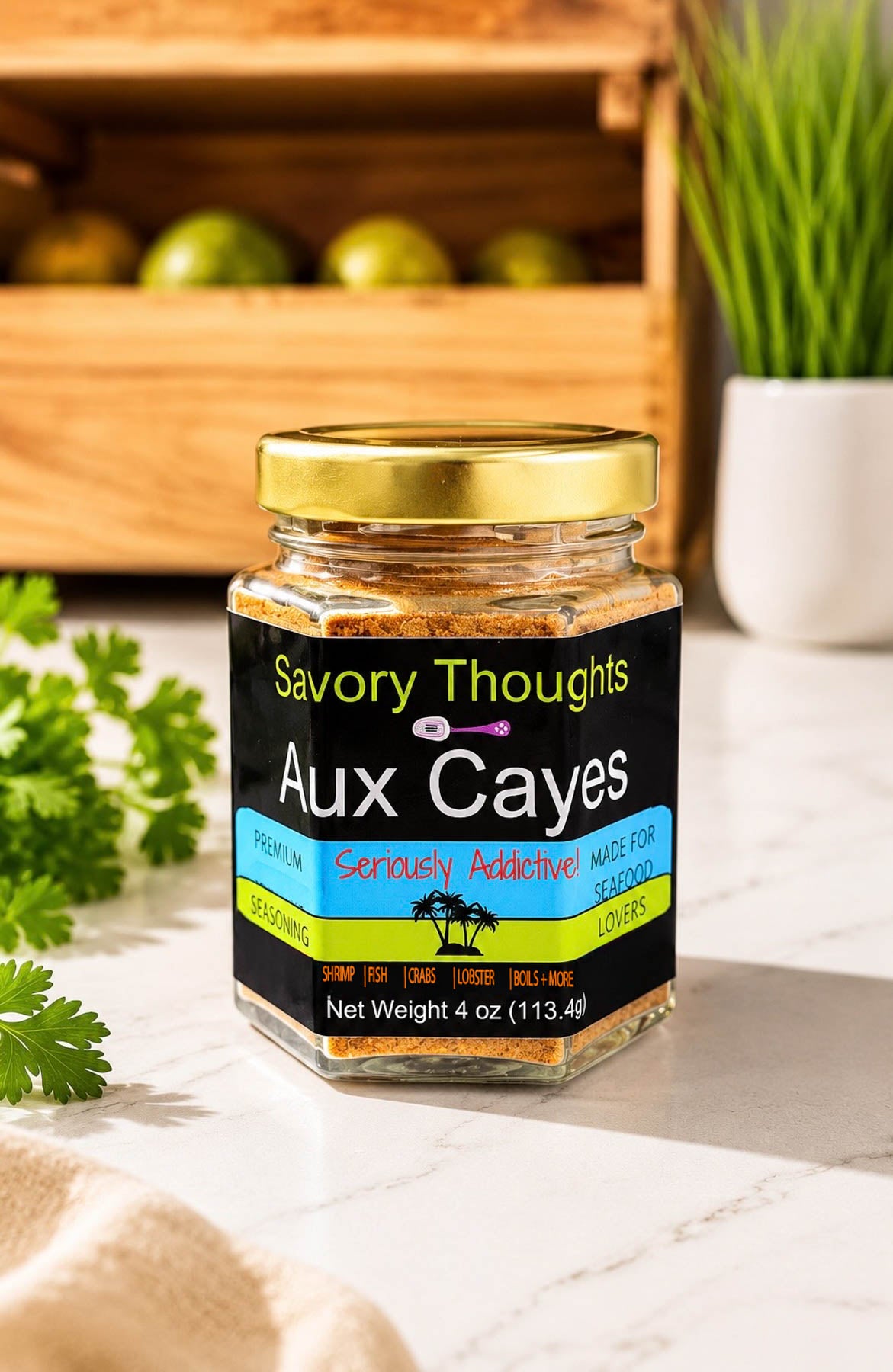 Jar of 'Savory Thoughts Aux Cayes' on a wooden surface with herbs and a plant in the background